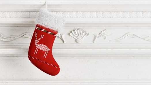 A red Christmas. stocking sits on a white mantle.
