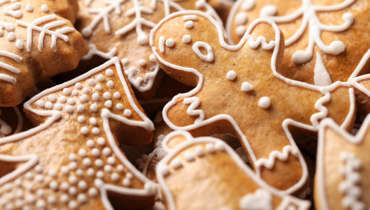 A stack of gingerbread cookies decorated with white frosting.